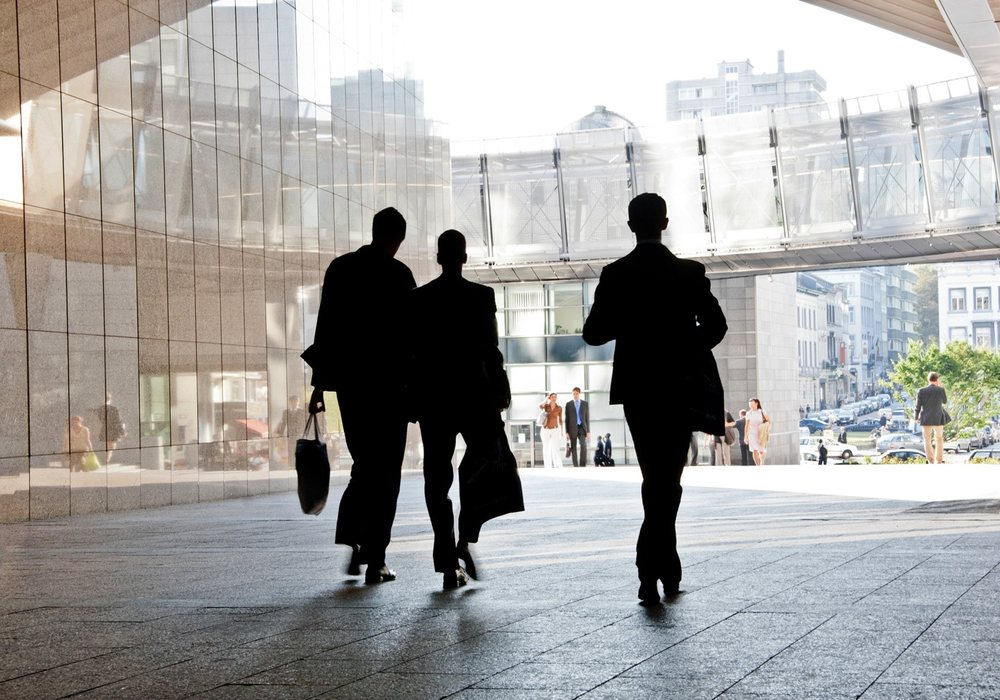 Professionals walking in an office lobby